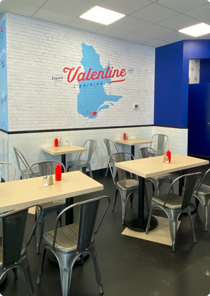 Modern diner interior featuring Valentine brand decor and simple table settings.