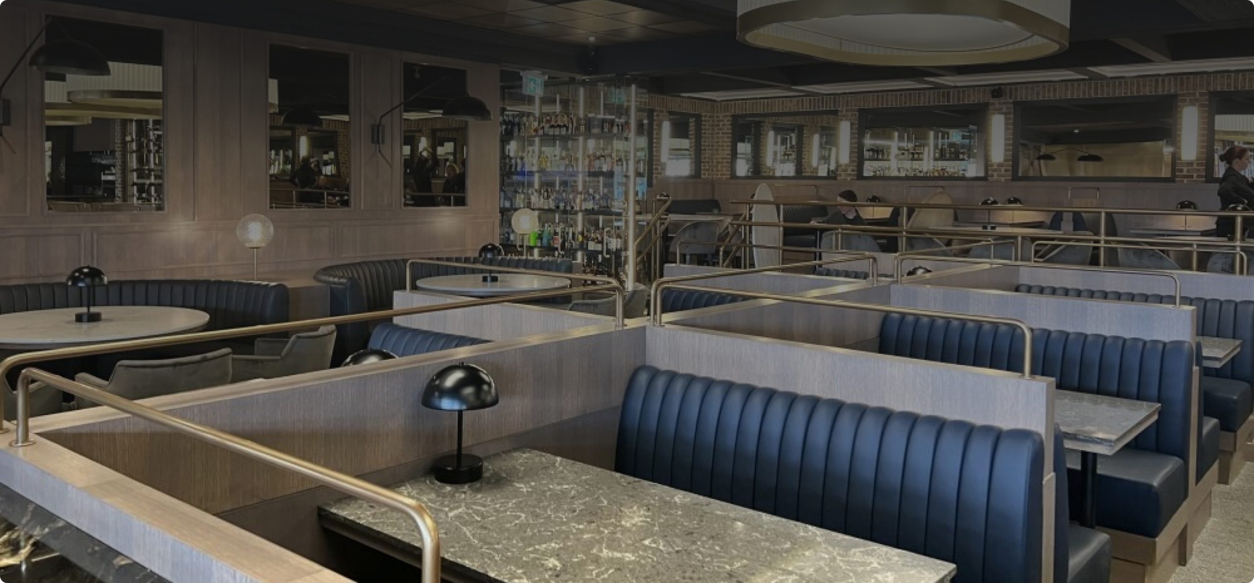 Modern restaurant interior with stylish booths and elegant lighting design.