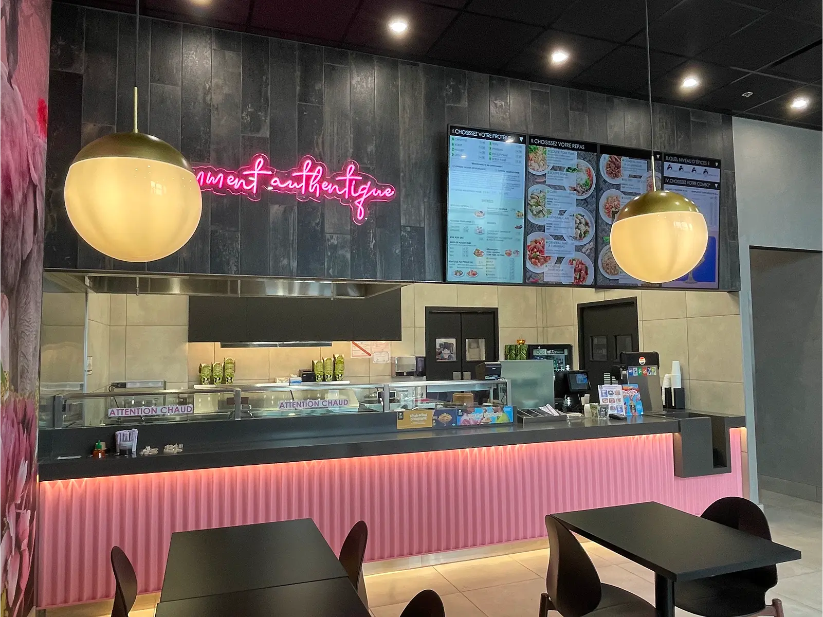 Exterior view of a Thaï Express food franchise store in Canada, showcasing modern design and vibrant signage