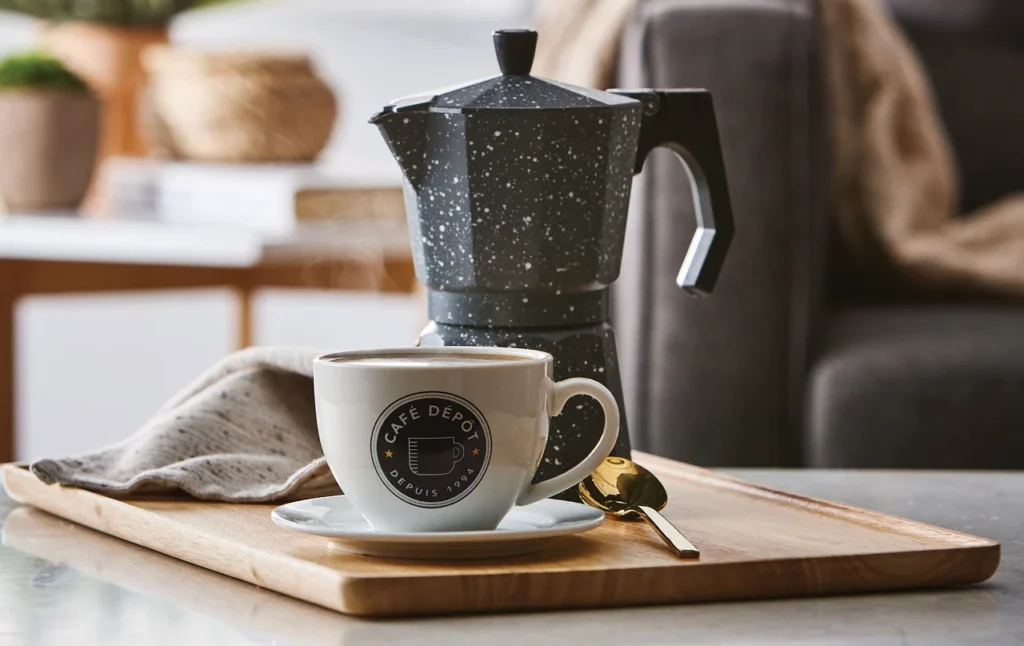 A freshly brewed Café Dépôt coffee with a French press, highlighting the brand’s premium coffee offerings.